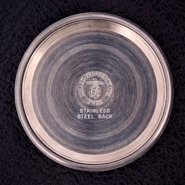 The Girard Perregaux Electronic Ref. 9280 6H Large Cushion Case features a round stainless steel case back with engraved text on a textured black surface.