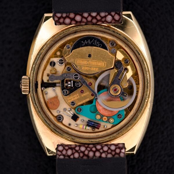 Close-up of the Girard Perregaux Electronic Ref. 9280 6H Large Cushion Case’s exposed inner mechanism, showcasing gold, metal, and colorful electronic components.