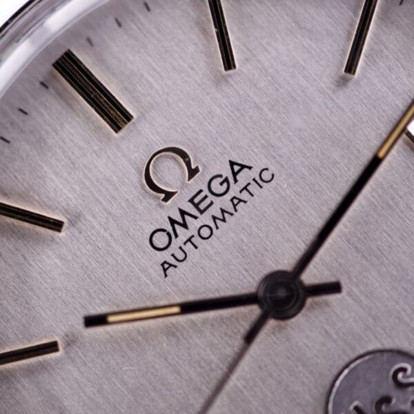 Close-up of the Omega Automatic Seamaster Ref. 166.020 For "U.S. Steel" Cal. 1010 Full Set watch face, highlighting the logo, text, and black and gold hour and minute hands powered by the Cal. 1010 movement.