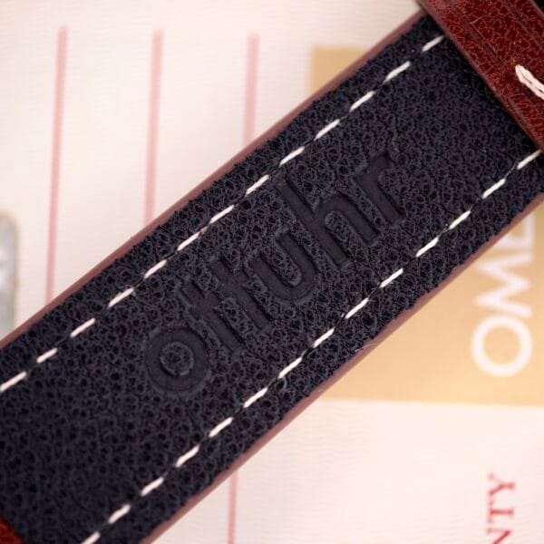Close-up of a black leather strap with otiuhr embossing and white edge stitching, designed to complement your Omega Automatic Seamaster Ref. 166.020 For "U.S. Steel" Cal. 1010 Full Set with timeless style and elegance.