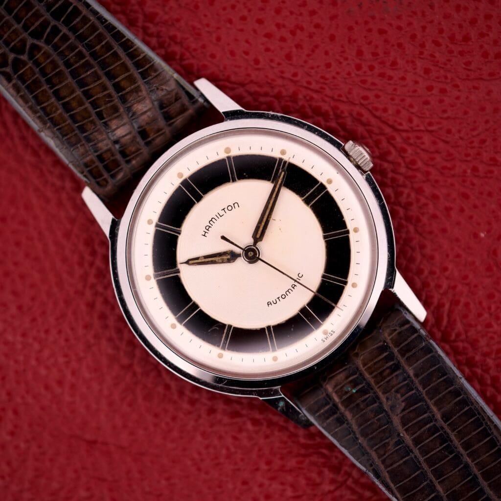 Hamilton Thin-o-matic T-500 Caliber 666 Automatic Micro-Rotor watch with a black and white dial and textured brown leather strap.