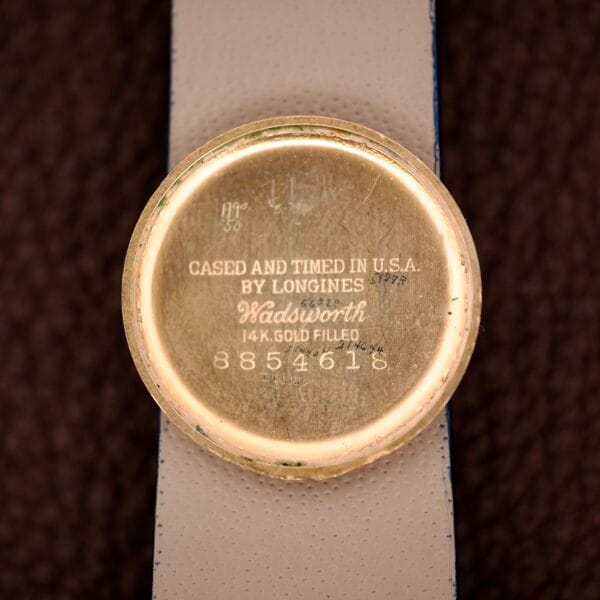 The Longines Mainliner Art Deco Drivers Watch Manual Wind Cal. 8L features a gold case back engraved "Cased and Timed in U.S.A. by Longines Wadsworth 14K Gold Filled," epitomizing classic Art Deco style in a standout drivers watch.