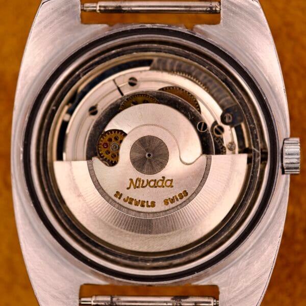 Close-up of the Nivada Automatic Antarctic Iceberg Date Ref. 4297 Sunburst Dial movement, highlighting gears and "21 Jewels Swiss" engraved on the rotor—distinctive details of this model.