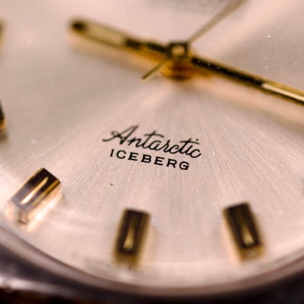Close-up of the Nivada Automatic Antarctic Iceberg Date Ref. 4297, showcasing a sunburst dial with gold hour markers and "Antarctic ICEBERG" on the face.