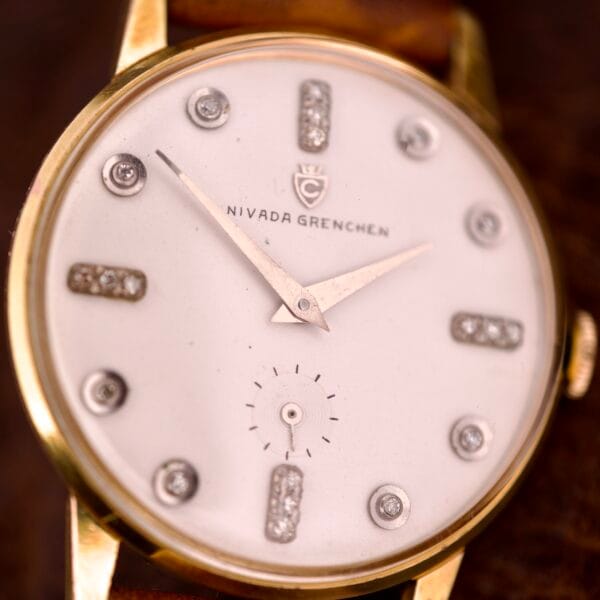 Close-up of the Nivada Grenchen Manual Wind Cal. R34, showcasing its white dial and diamond markers.