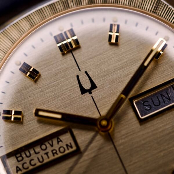 Close-up of the Bulova Accutron Turning Fork Cal. 2182 Day-Date Cushion Case, showcasing the signature Turning Fork logo and Day-Date indicators on its watch face.