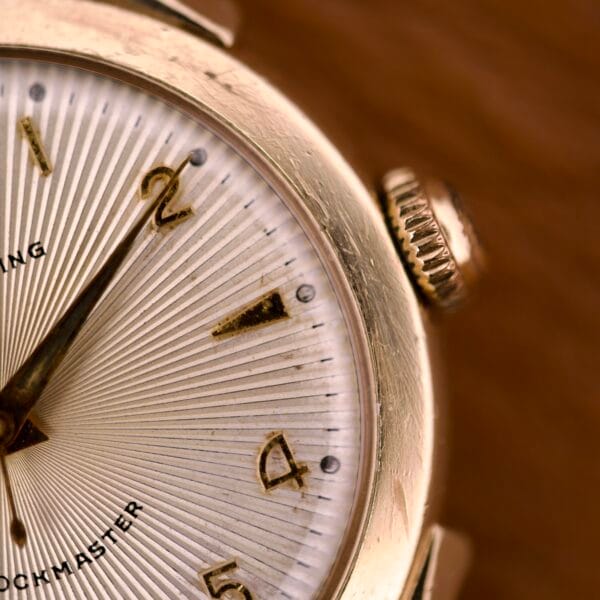 Close-up of the Elgin Automatic Shock-Master Guilloché Dial Cal. 643, showcasing gold hour markers, detailed numbers 1-3, and a refined guilloché-patterned dial.