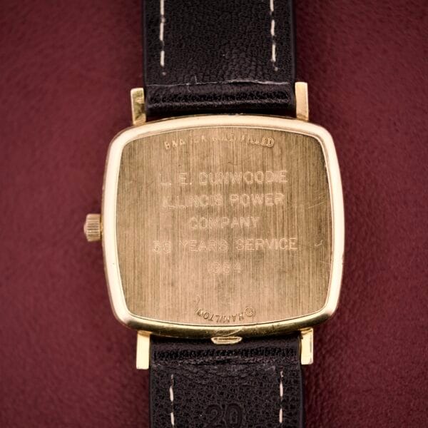 Hamilton Masterpiece Ref. 9116 10K Gold Filled TV Case Quartz with black leather strap, engraved "Illinois Power Company 55 Years Service 1957" on the back.