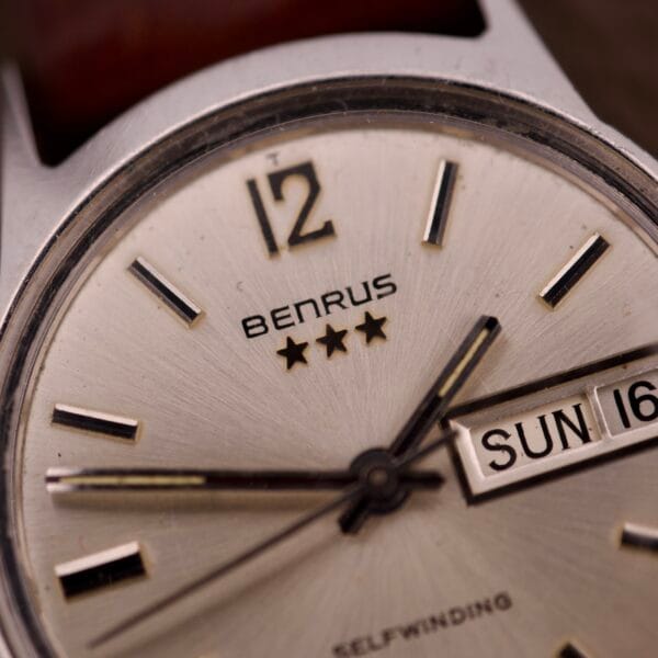 Close-up of the Benrus Three Star Automatic Day-Date Sunburst Dial #7001 Series, showcasing its metallic hour markers and striking sunburst dial.