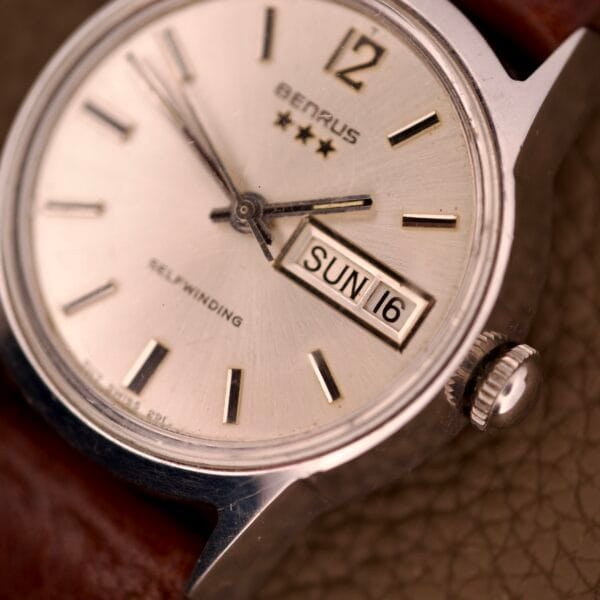 Close-up of a Benrus Three Star Automatic Day-Date Sunburst Dial #7001 Series wristwatch, showing the day and date as SUN 16.