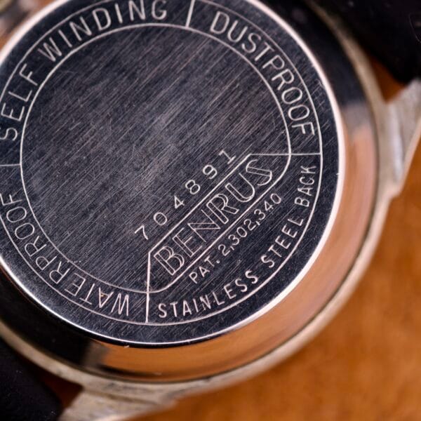 Close-up of the Benrus Three Star Automatic Browned Tropic Dial Stainless Steel watch back displaying serial numbers and text like SELF WINDING, DUSTPROOF, and Stainless Steel.