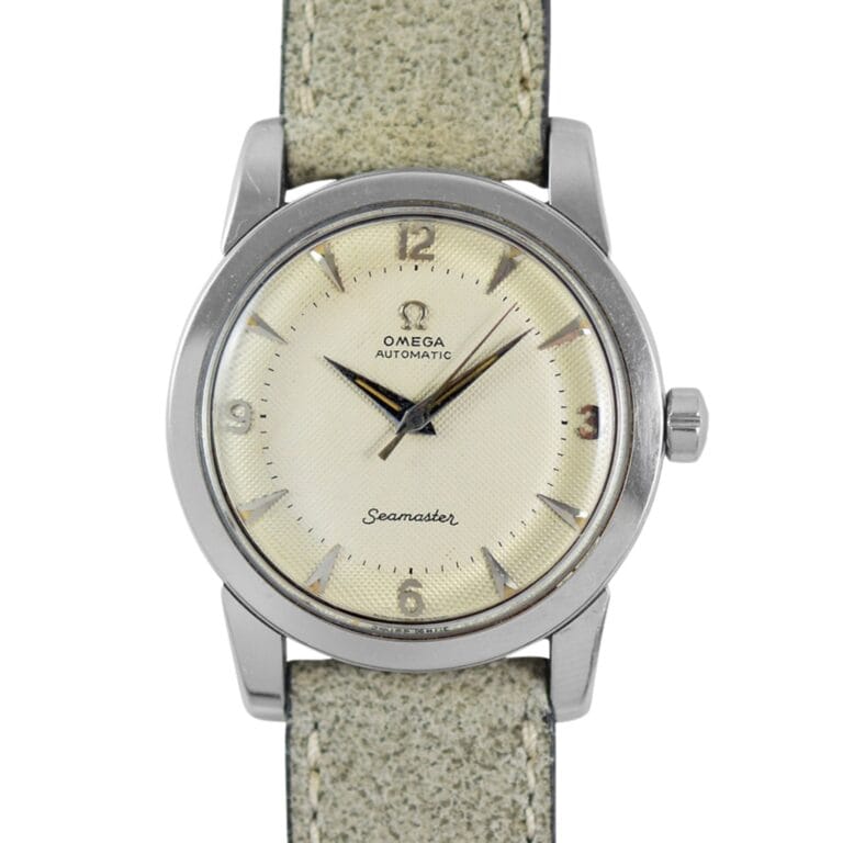 Vintage Omega Seamaster CK 2767 watch with a cream dial, silver hour markers, and a textured light gray strap.