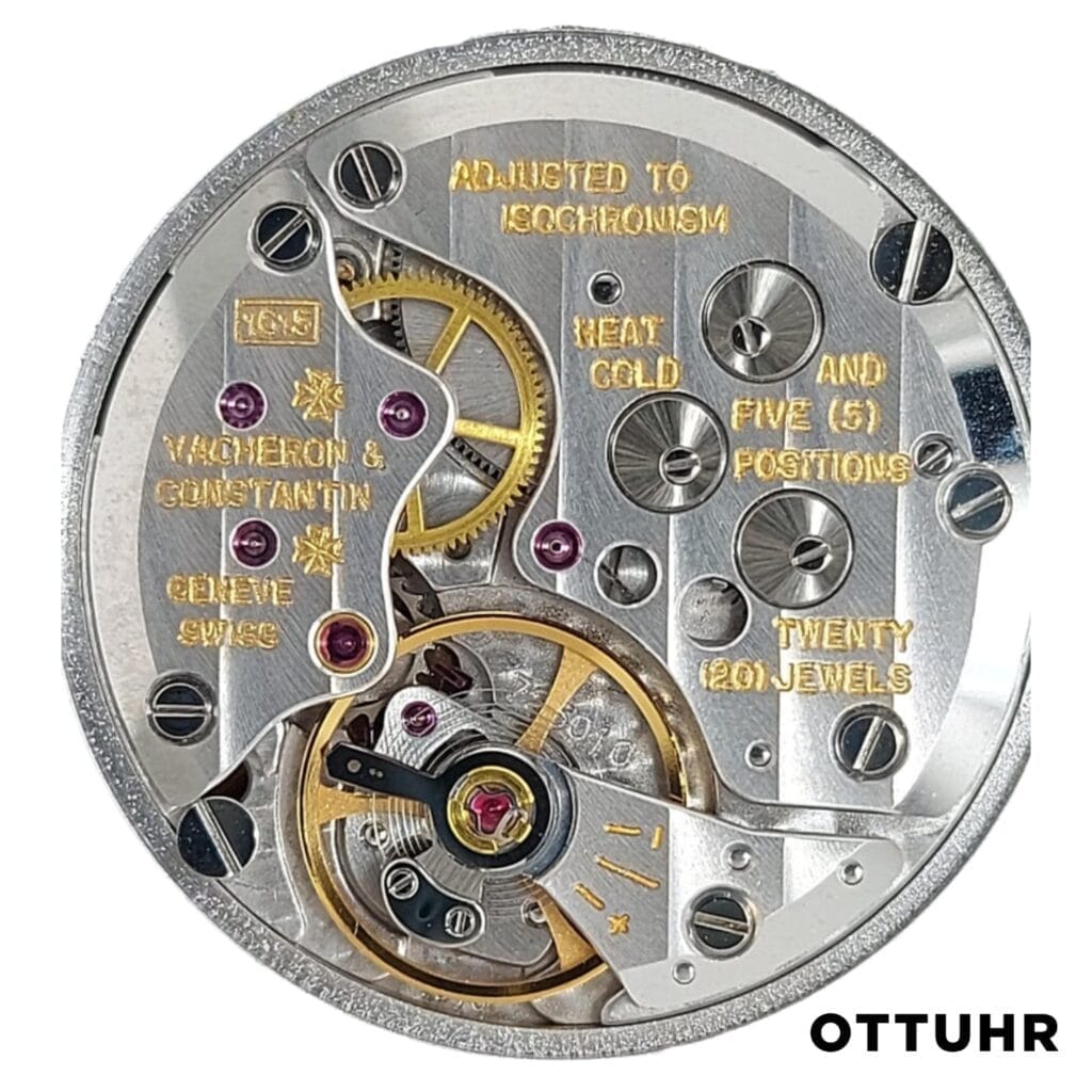 Close-up of a Vacheron Constantin 1015 watch movement with exposed gears and engraved gold text.