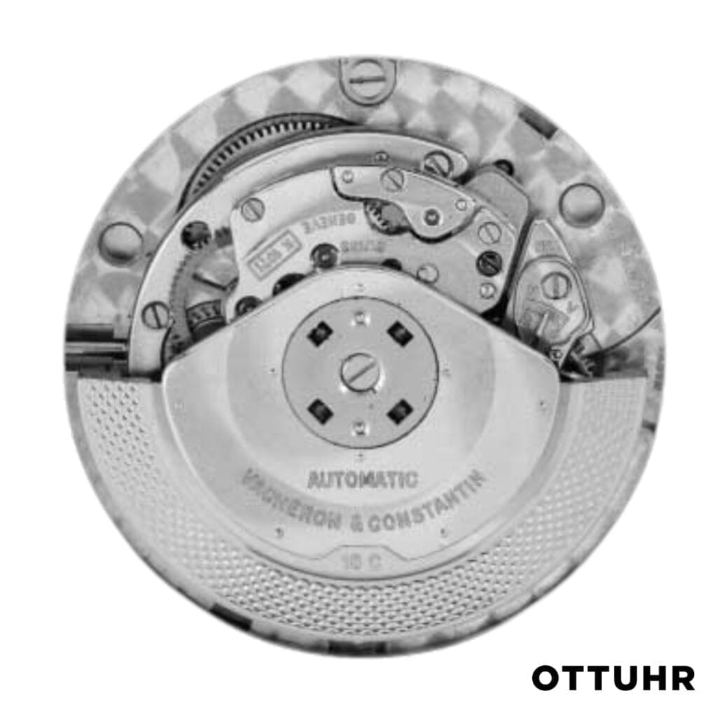 Close-up of a mechanical watch movement with visible gears, reminiscent of Vacheron Constantin craftsmanship, labeled OTTUHR in the bottom right corner.