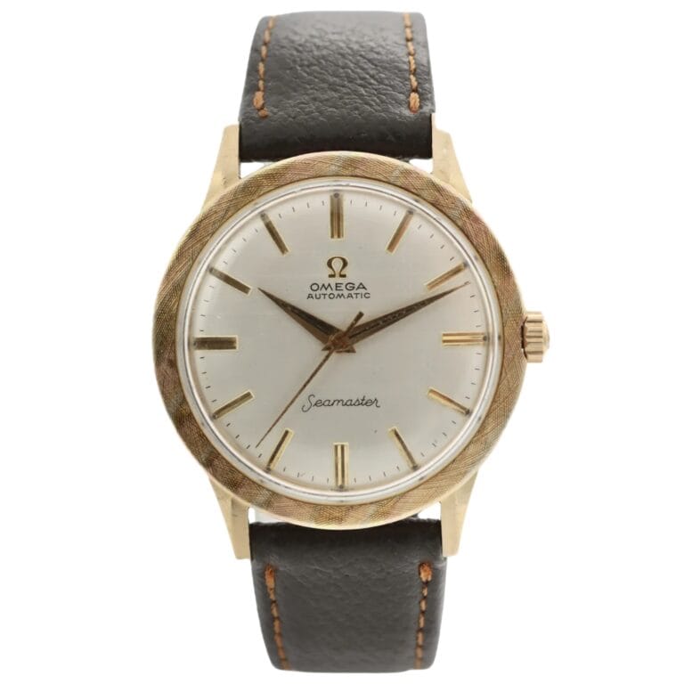 A vintage Omega Seamaster L6300 watch with a gold case, white dial, and black leather strap.