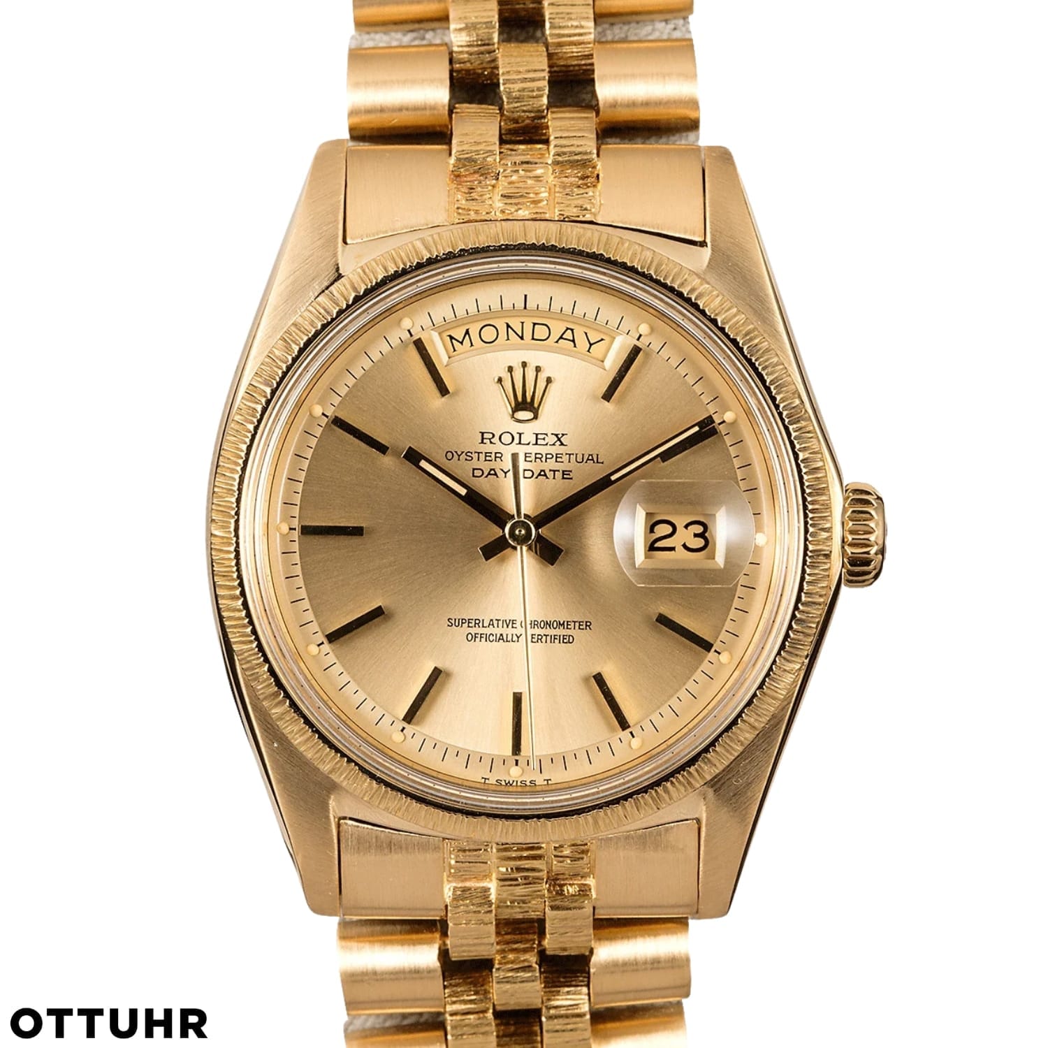 A gold Rolex Day-Date 1807 watch showing Monday and the 23rd on its dial with a stunning gold link bracelet.