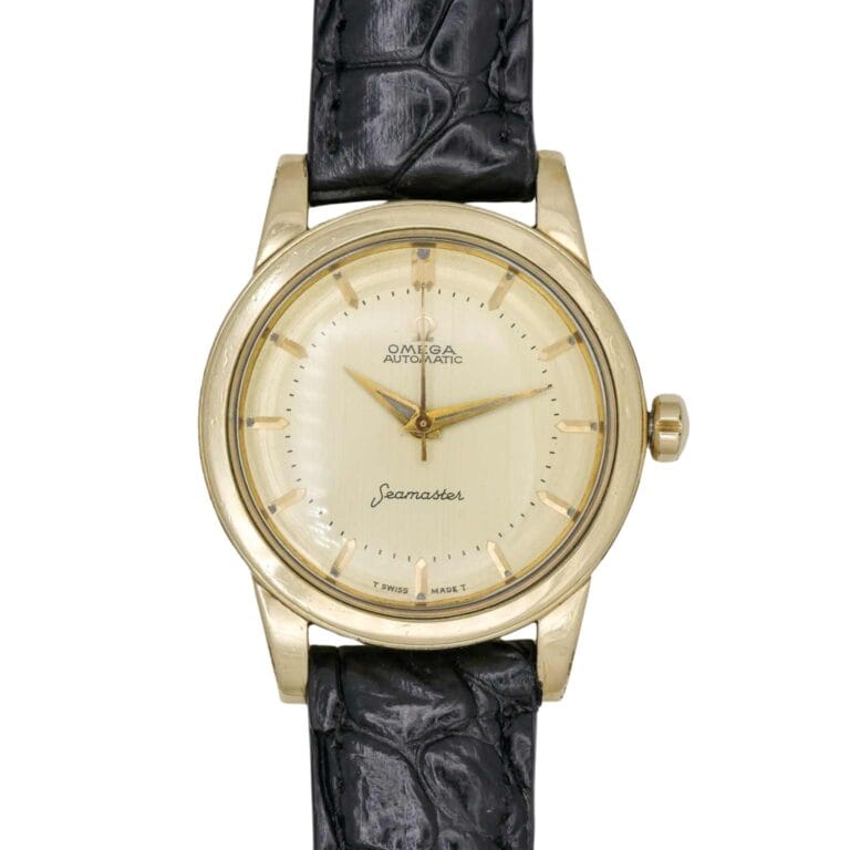 Gold Omega Seamaster 6250 wristwatch with a cream dial and black leather strap, showing the time at 12:05.