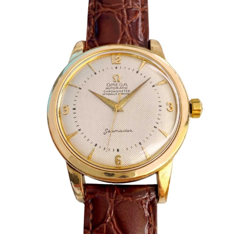 Gold Omega Seamaster 2494 wristwatch with a brown leather strap and a textured white dial.