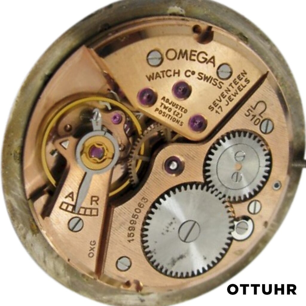 Close-up of an Omega Swiss 510 watch movement showing gears, jewels, and engraved text on metal parts.