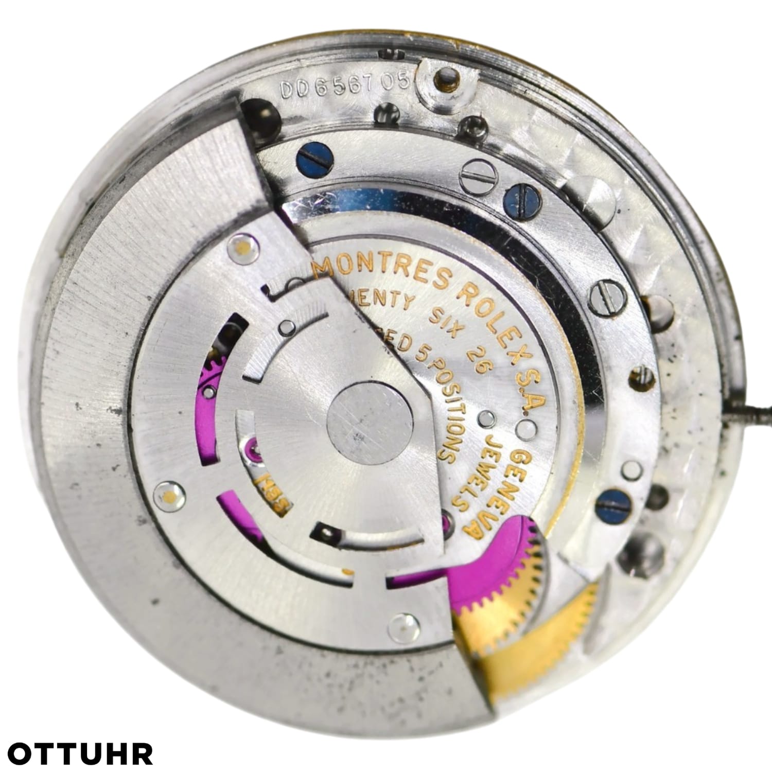 Close-up view of a Rolex 1556 watch movement with visible gears, rotor, and engraved markings.