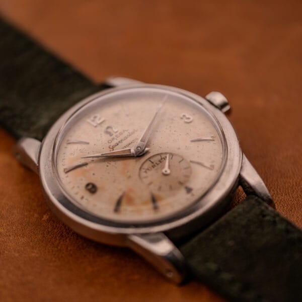 Wide angled view of Omega Seamaster Bumper Türler dial with cream patina and applied dart hour markers