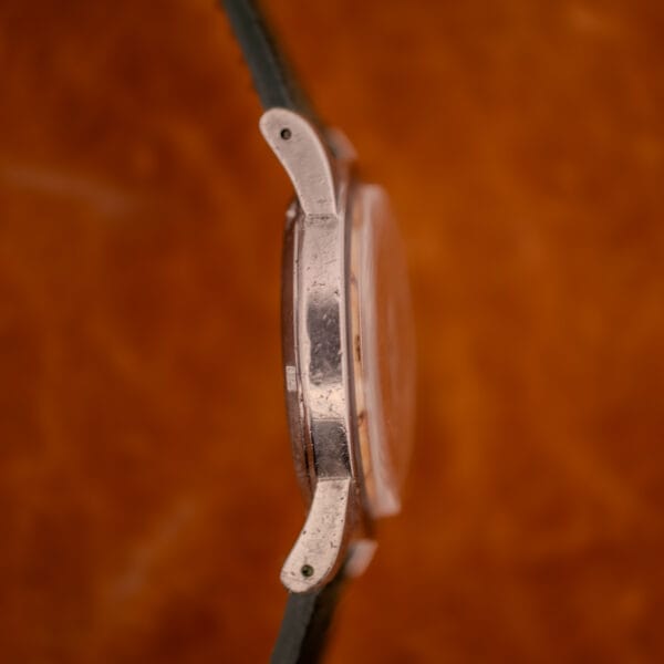 Opposite side profile of Omega Seamaster Bumper case showing thick lug architecture and case flank wear