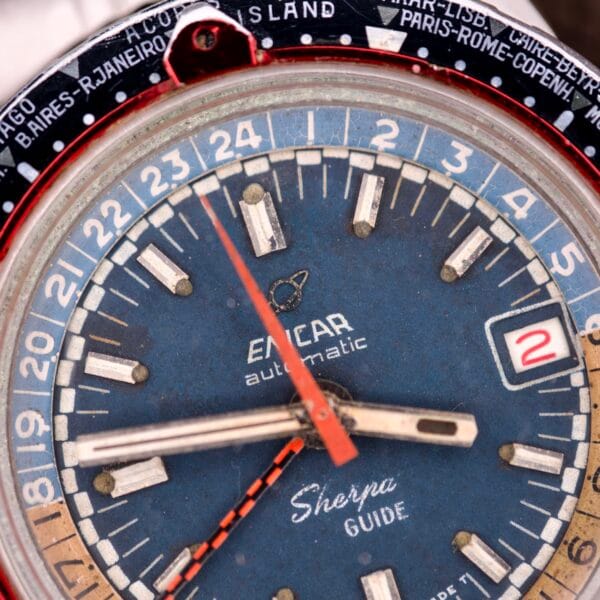 Close-up of an Enicar Sherpa Guide 600 "Pepsi" Automatic World Timer GMT Ref. 2342, showcasing the time, date, and its vintage blue dial that embodies classic Enicar craftsmanship.