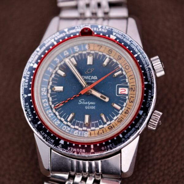 The Enicar Sherpa Guide 600 "Pepsi" Automatic World Timer GMT Ref. 2342 features a bold blue dial, red-and-blue bezel, and metal band—an iconic timepiece for Enicar collectors.