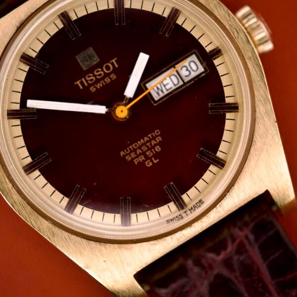 Close-up of a Tissot Seastar PR 516 GL Ref. 46572 wristwatch featuring a maroon dial, day/date display (Wednesday the 30th), and powered by Cal. 794 movement.