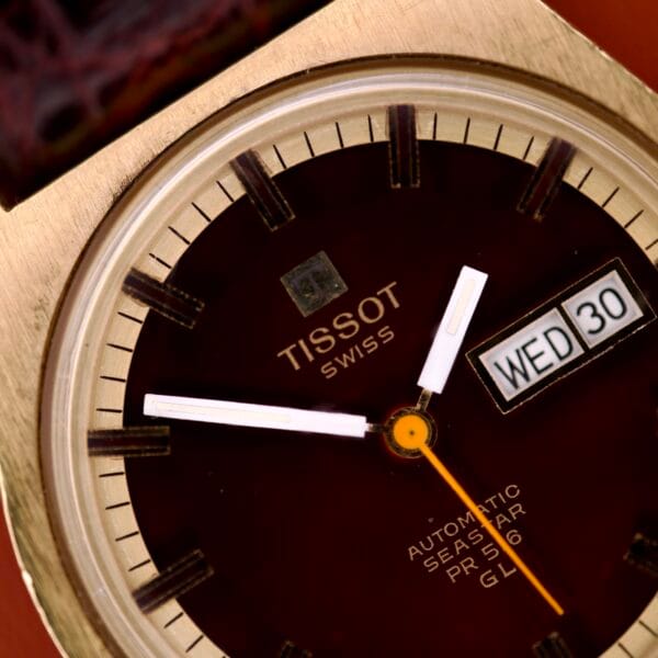 Close-up of a Tissot Seastar PR 516 GL Maroon Dial Ref. 46572 Day/Date Cal. 794 wristwatch showing 8:19, with the day-date display set to Wednesday the 30th.