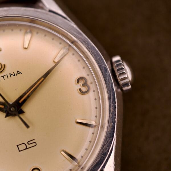 Close-up of a Certina DS Ref. 346.825 1st Gen wristwatch with Cal. 25-36 movement, showcasing the dial, hands, and the number 3 on its stainless steel case face.
