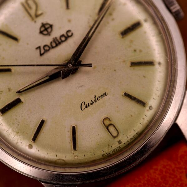 Close-up of the Zodiac Hermetic Custom Manual Wind in Stainless Steel Case, highlighting its dial, hands, and the visible wear and age marks on the case.