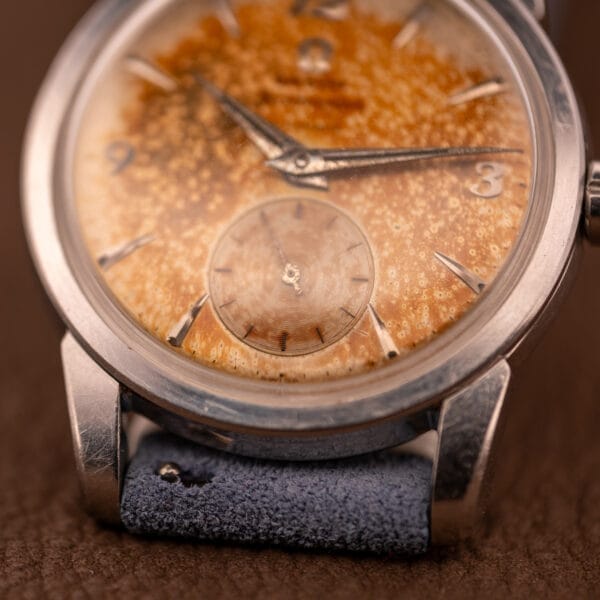 Close-up of an Omega Seamaster Automatic Tropic Dial Ref. 2848 Cal. 490, featuring a heavily patinated dial and a blue suede strap.