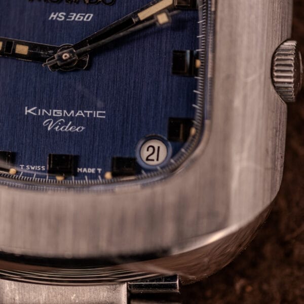 Close-up of the Movado HS 360 Kingmatic Video Blue Dial Ref. 409-705 Cal. 408 watch face, featuring a blue dial and date window displaying "21".