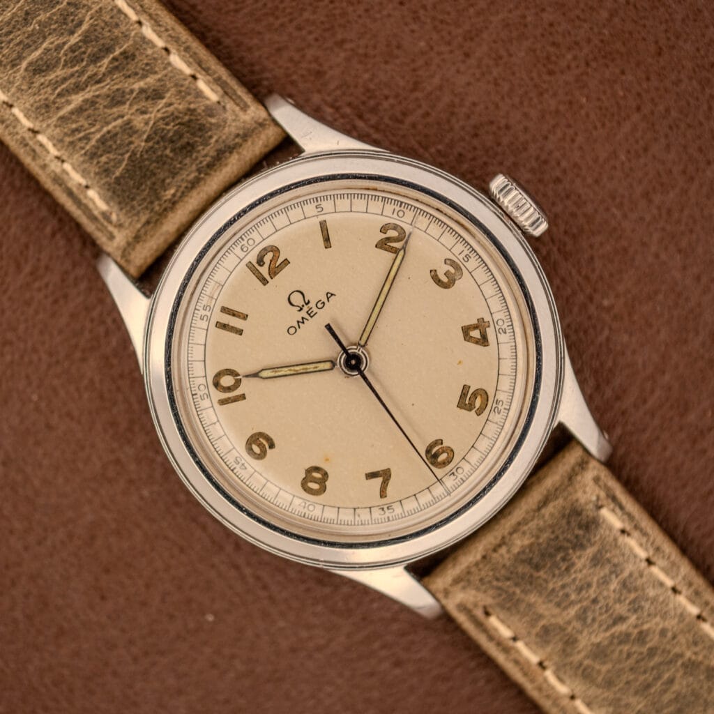 Omega WWII Era Military "US ARMY" Ref. 2179 Stainless Steel Cal. 30T2 SC, featuring a beige dial and brown leather strap—a classic timepiece inspired by those worn by the US Army during WWII.
