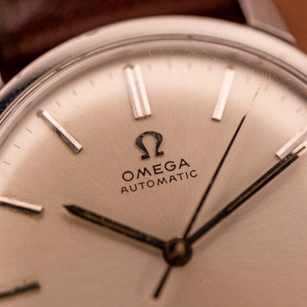 Close-up of an Omega Automatic Seamaster Geneve Double Signed Dial Ref. 165.002, highlighting the watch face with its detailed hands and hour markers.