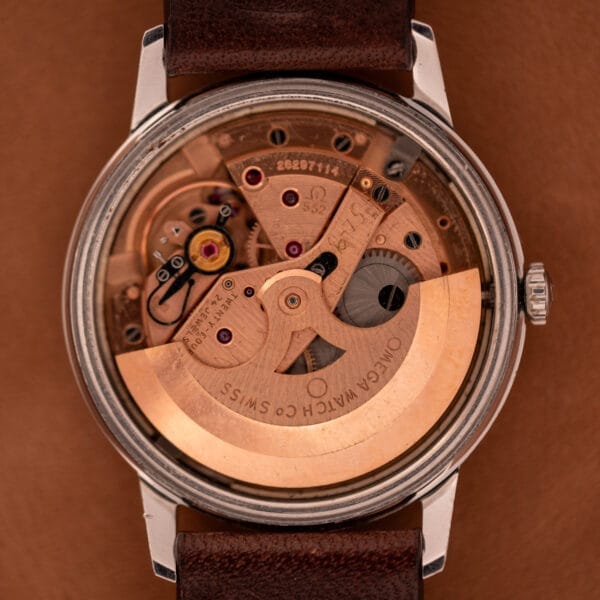 Close-up of the inner mechanical movement of an Omega Automatic Seamaster Geneve Double Signed Dial Ref. 165.002, showcasing its visible gears and automatic rotor.