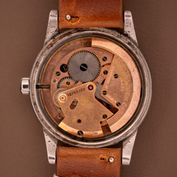 A close-up of the Omega Automatic Seamaster Bumper "Türler Dial" Ref. 2576, showcasing its visible gears and mechanisms, paired with a brown leather strap and no watch face.