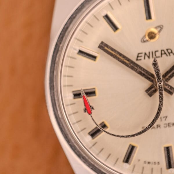 Close-up of an Enciar Ocean Peal 17 Star Jewels "Space Ship Seconds" Ref. 2334 watch face, showing a red-tipped hand and bold black hour markers.