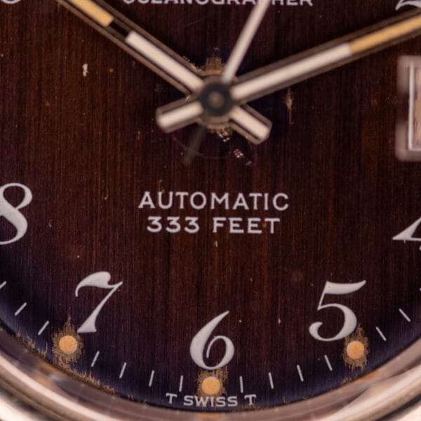 Close-up of a Bulova Oceanographer Automatic 333 Feet watch face, Cal. 1132.10, with blue/purple dial showing "AUTOMATIC 333 FEET" above the numbers 6 and 5.