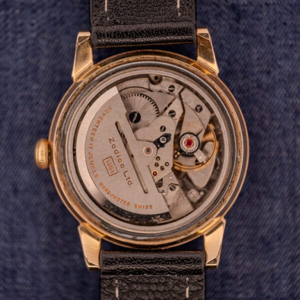 Close-up of the inner mechanical movement of the Zodiac Glorious Automatic Tuxedo Dial Ref. 688 Cal. 1361, highlighting its fine craftsmanship against a blue fabric background.