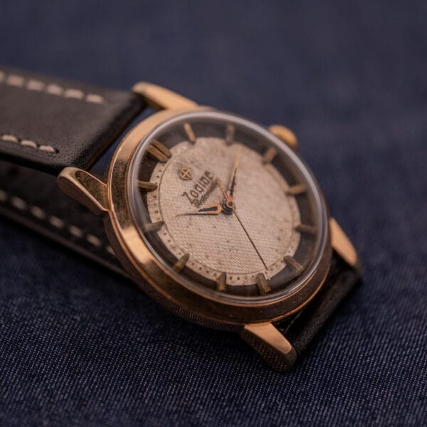 Close-up of the Zodiac Glorious Automatic Tuxedo Dial Ref. 688 Cal. 1361 with a leather strap, set against denim fabric.