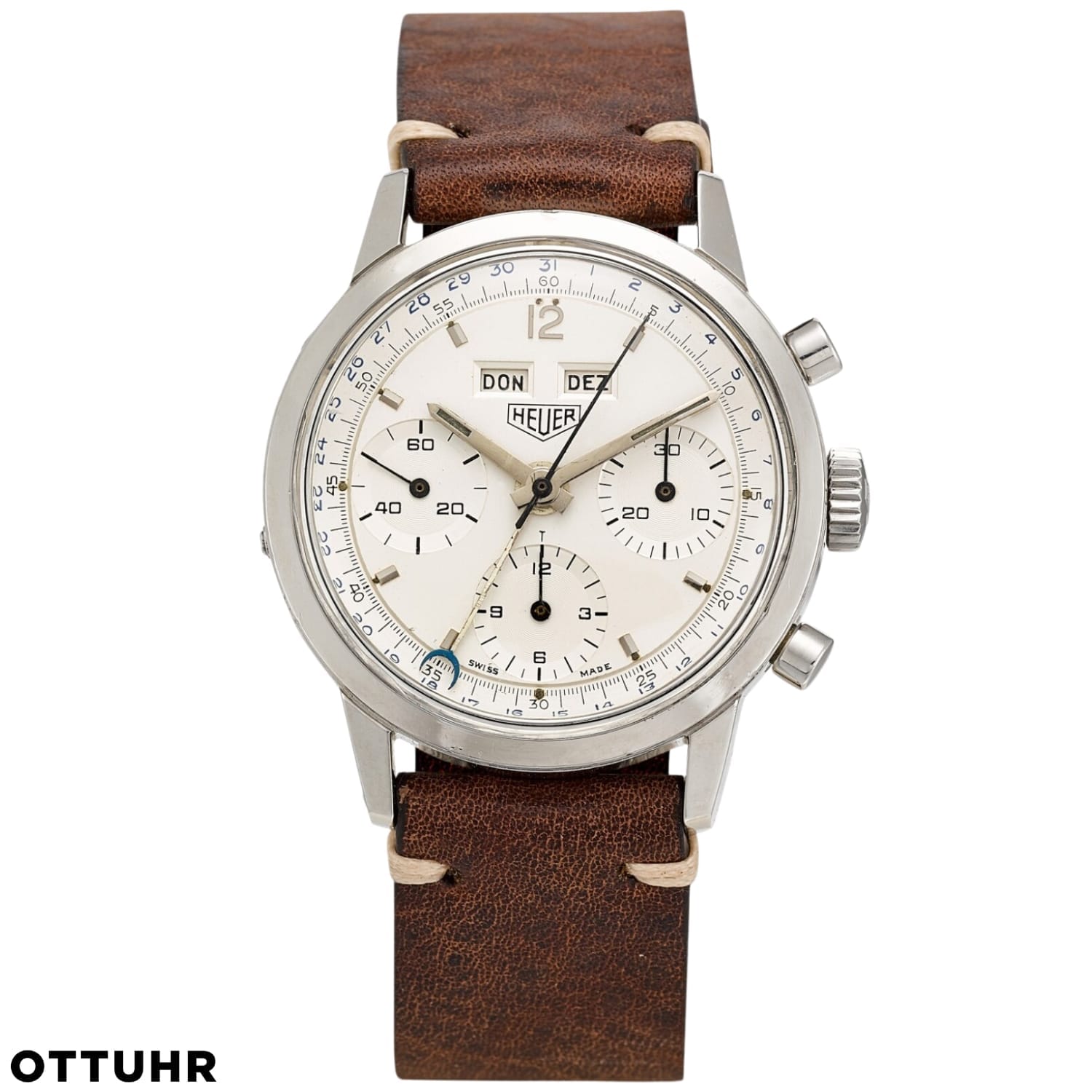 Vintage Heuer 2547S chronograph watch with a brown leather strap and a white dial displaying day and date.