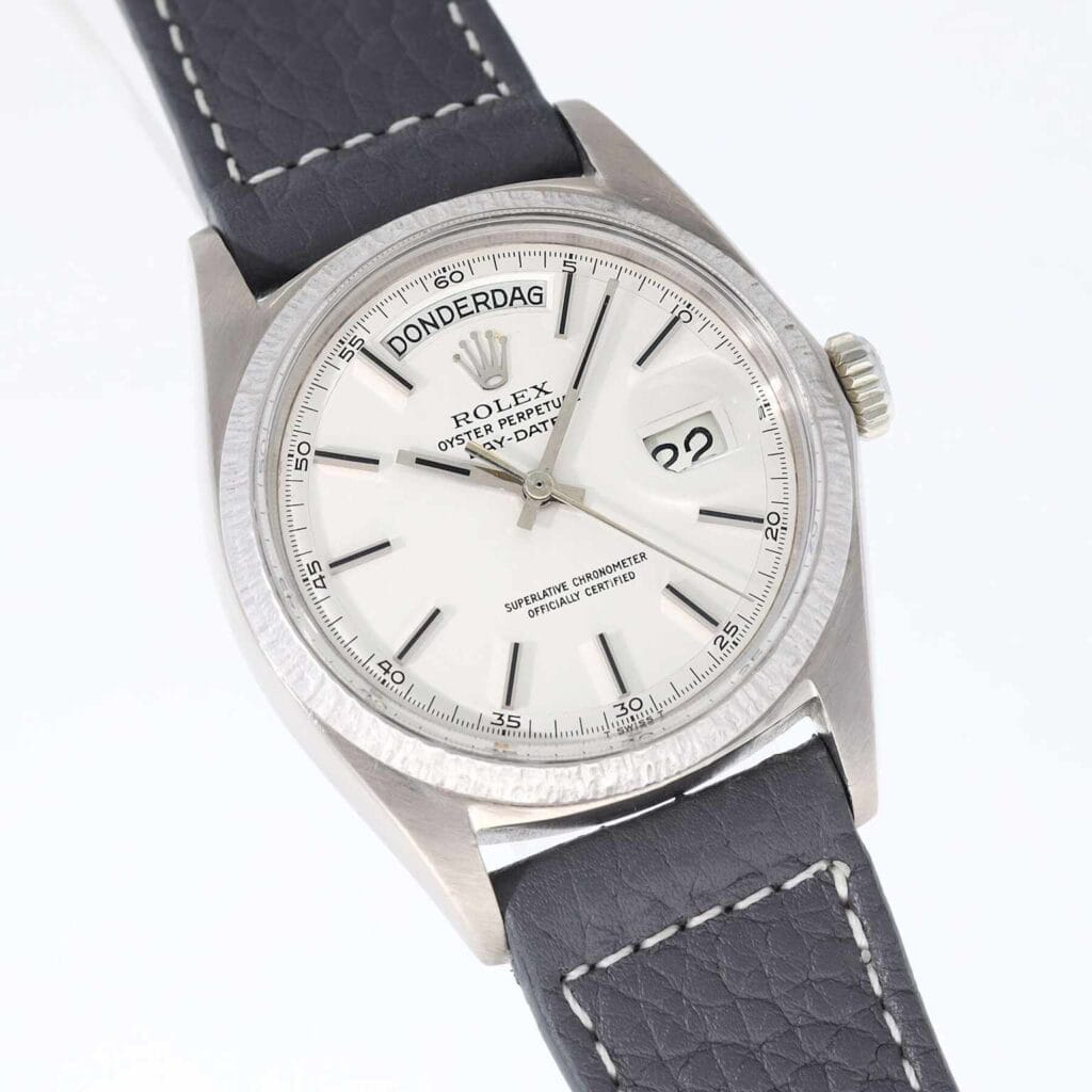 Silver Rolex day-date 1807 watch with gray strap