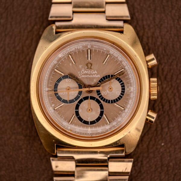 Omega Seamaster Chronograph Ref 145.029 with Cal. 861 movement and three subdials, showcased on a brown leather background.