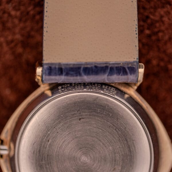 Close-up of the Wittnauer Automatic Ref. 2598-1 Hooded Lugs Cal. 11SR, featuring a 10K Gold Filled bezel, stainless steel back, and unique hooded lugs engraved on the case.