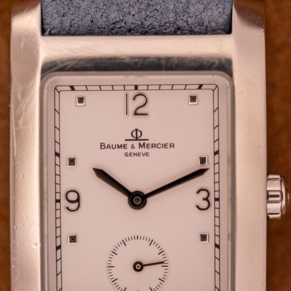 Close-up of the Baume Mercier Hampton Large MV05063, a rectangular wristwatch with a white dial quartz face and elegant silver casing.