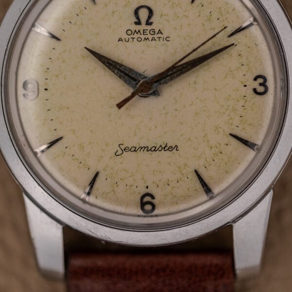 Close-up of the Omega Automatic Seamaster Ref. 2846-2848 in stainless steel, featuring a cream dial, Cal. 500 movement, and a brown leather strap.