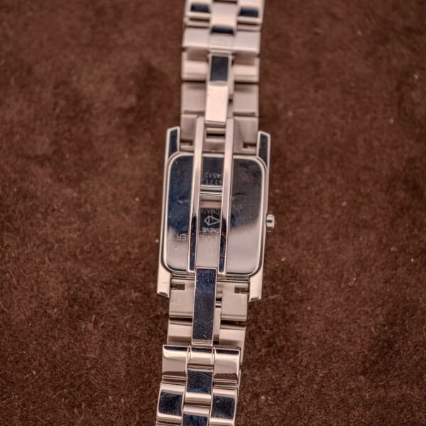 Baume Mercier Hampton MV045120 reverse view of solid caseback and bracelet underside, polished stainless steel construction with engraved markings.