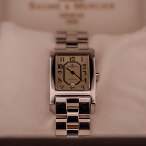 Baume Mercier Hampton Automatic Large MV045120 presented inside original B&M box cushion, rectangular case and dial centered on white pillow.